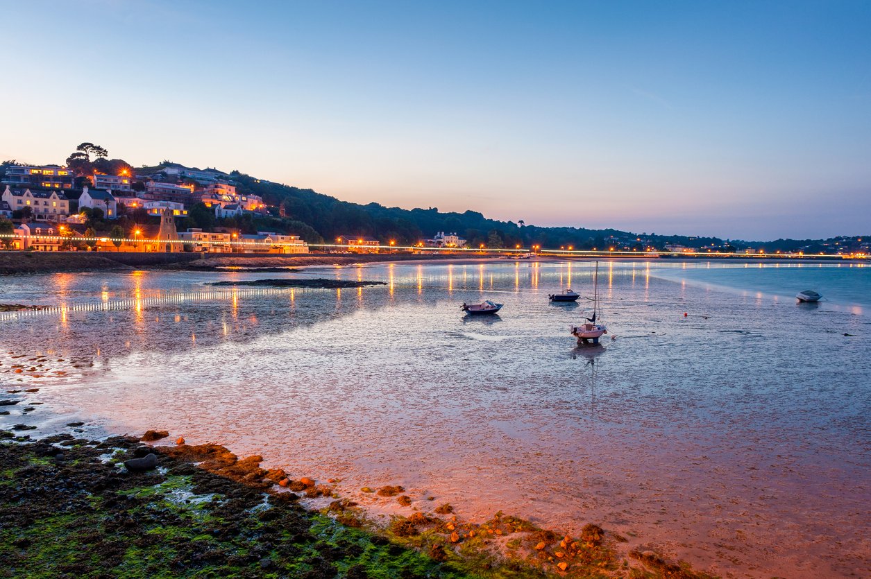Coastline of Saint Aubin Jersey at low tide and sunset