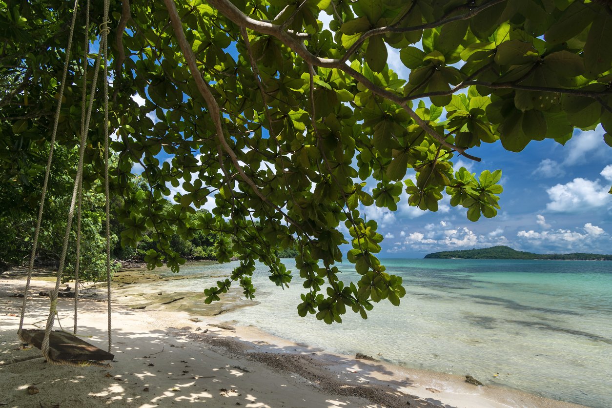 wood swing on empty beach in koh ta kiev paradise island near sihanoukville in cambodia