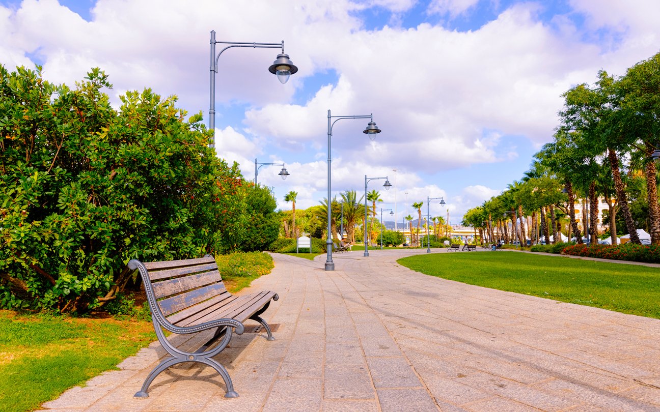 Bench at Parco Giardinetti Park in Old city of Olbia reflex