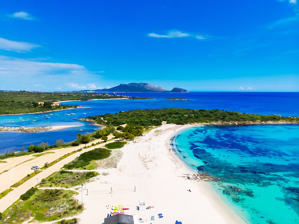 Aerial view of Bados, nice sandy beach with the mountains and the islands in background, North Sardinia,Olbia