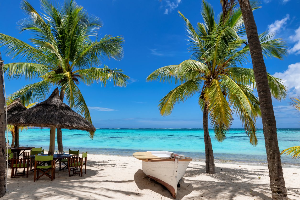 Beach cafe and boat in sandy beach