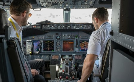 two pilots sitting inside plane