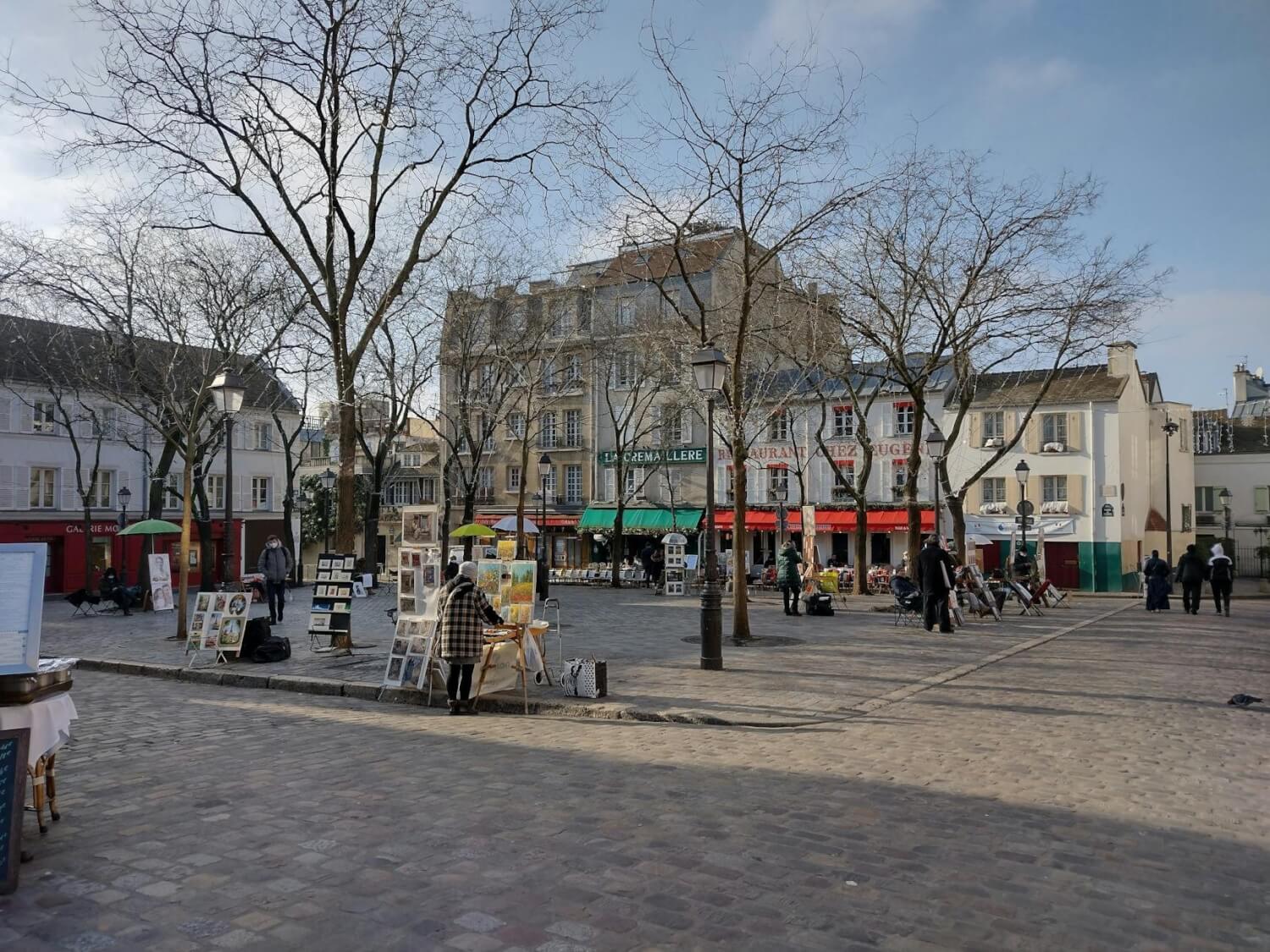 charming montmartre street with artists in paris