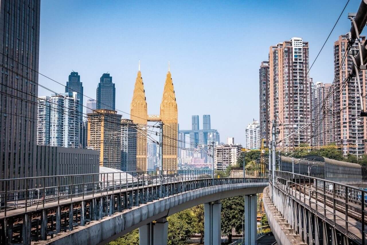 white bridge over the city during daytime